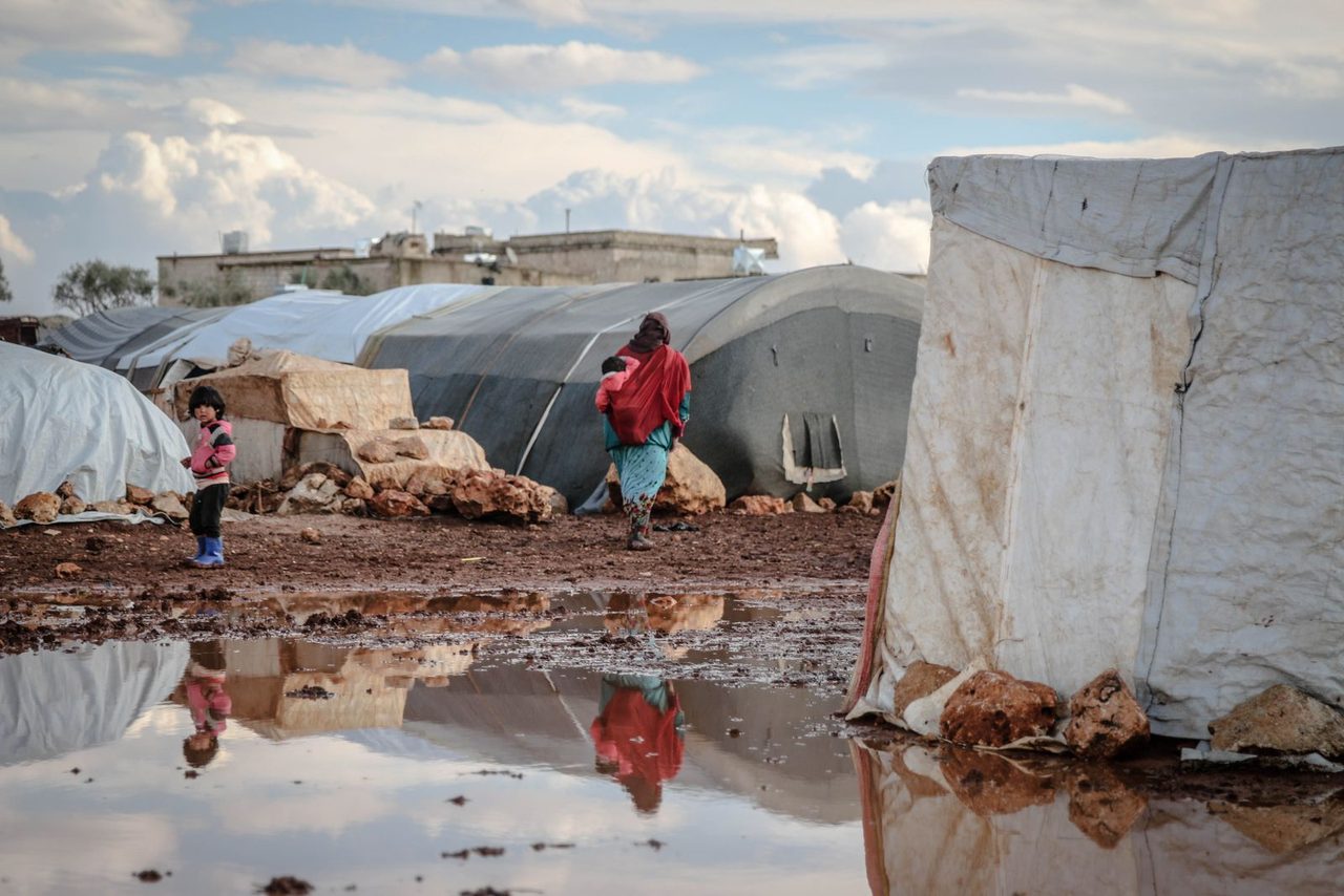 An evacuation center fills up as the border town struggles to cope with the influx.