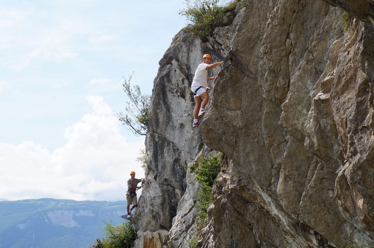 Climbers working their way up a steep alpine line — the high-stakes reality of Himalayan mountaineering.