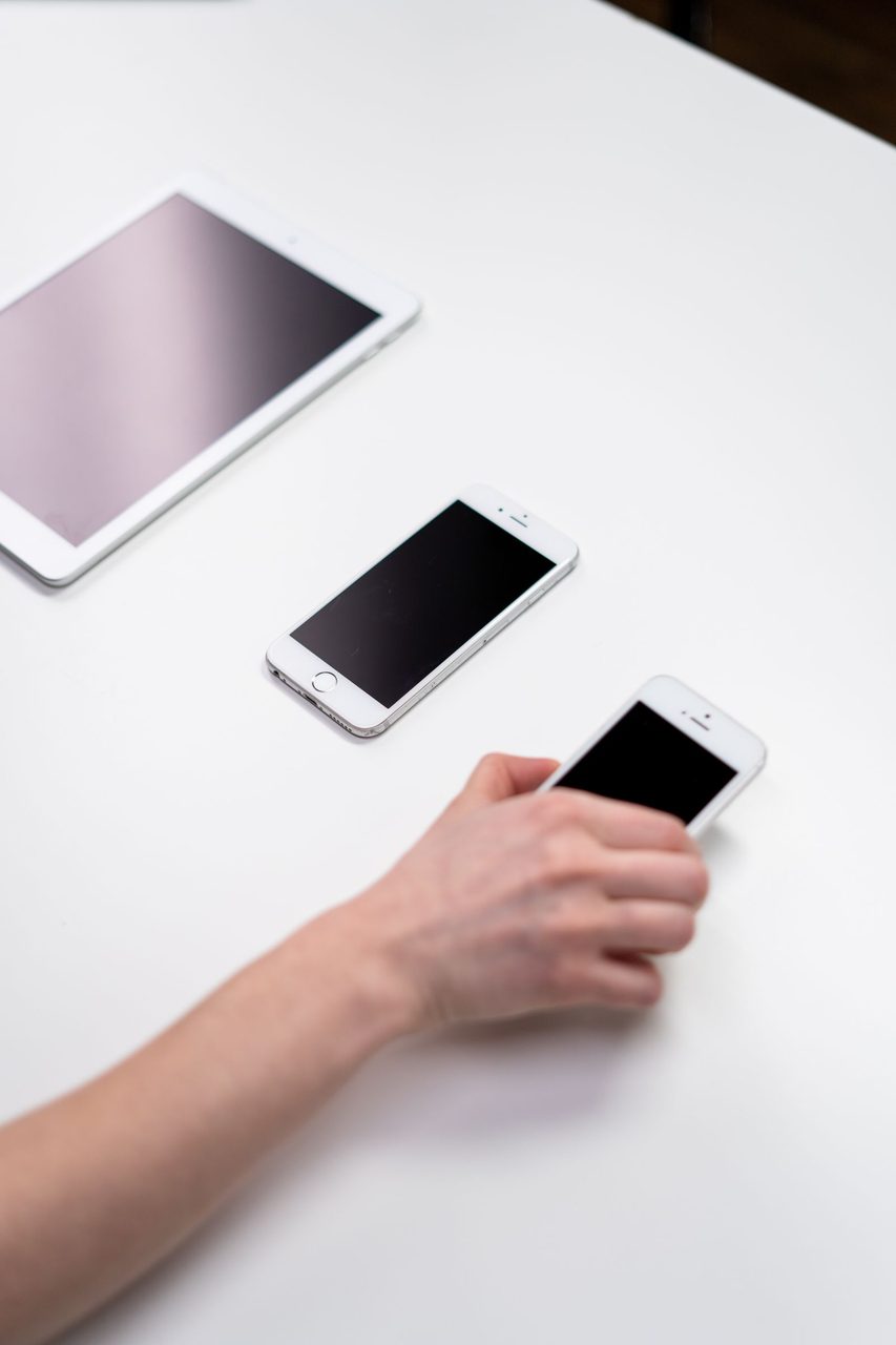 An iPhone beside an iPad - Apple services and devices are increasingly intertwined.